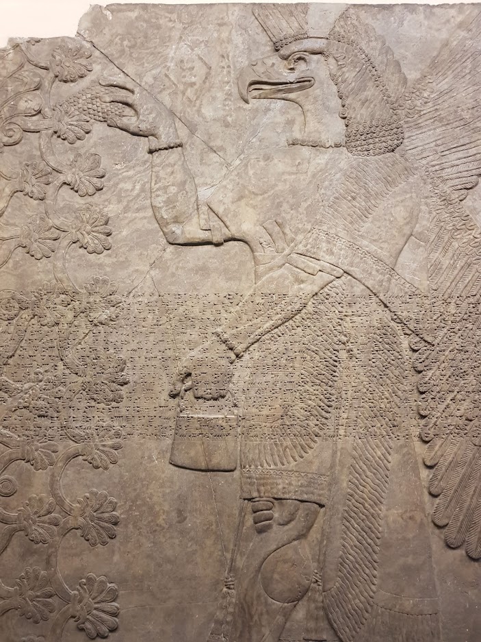 Bas-relief of Assyrian eagle-headed attendant with basket.